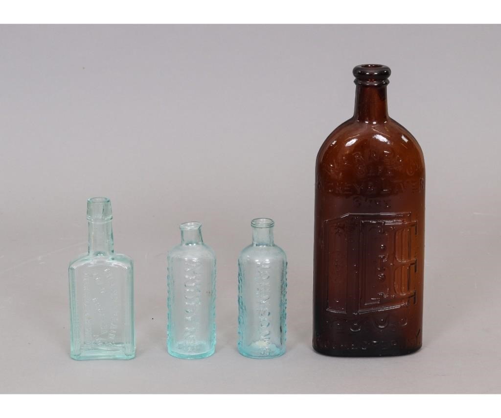 Appraisal: Four glass medicine bottles to include a pair of linament