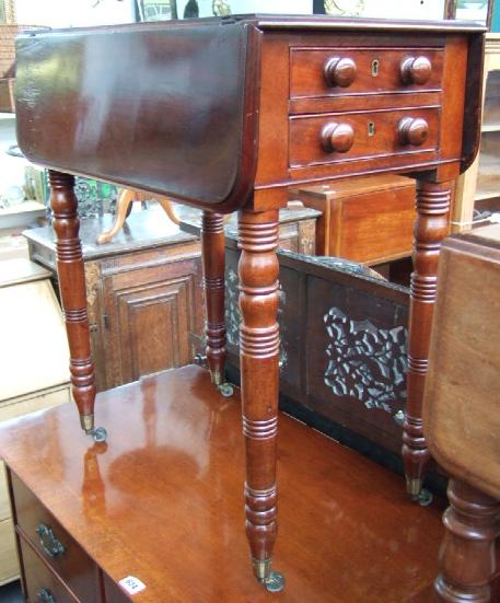 Appraisal: A Victorian mahogany drop flap work table with a pair