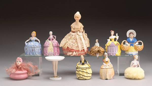 Appraisal: A collection of thirteen porcelain powder puff figures and figural