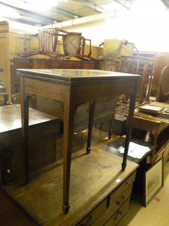 Appraisal: An Edwardian mahogany and boxwood strung card table on square