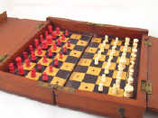 Appraisal: An Edwardian mahogany travelling chess set with inlaid ebony and