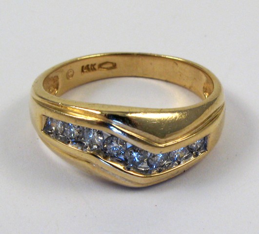 Appraisal: MAN'S DIAMOND AND FOURTEEN KARAT GOLD RING set with eight