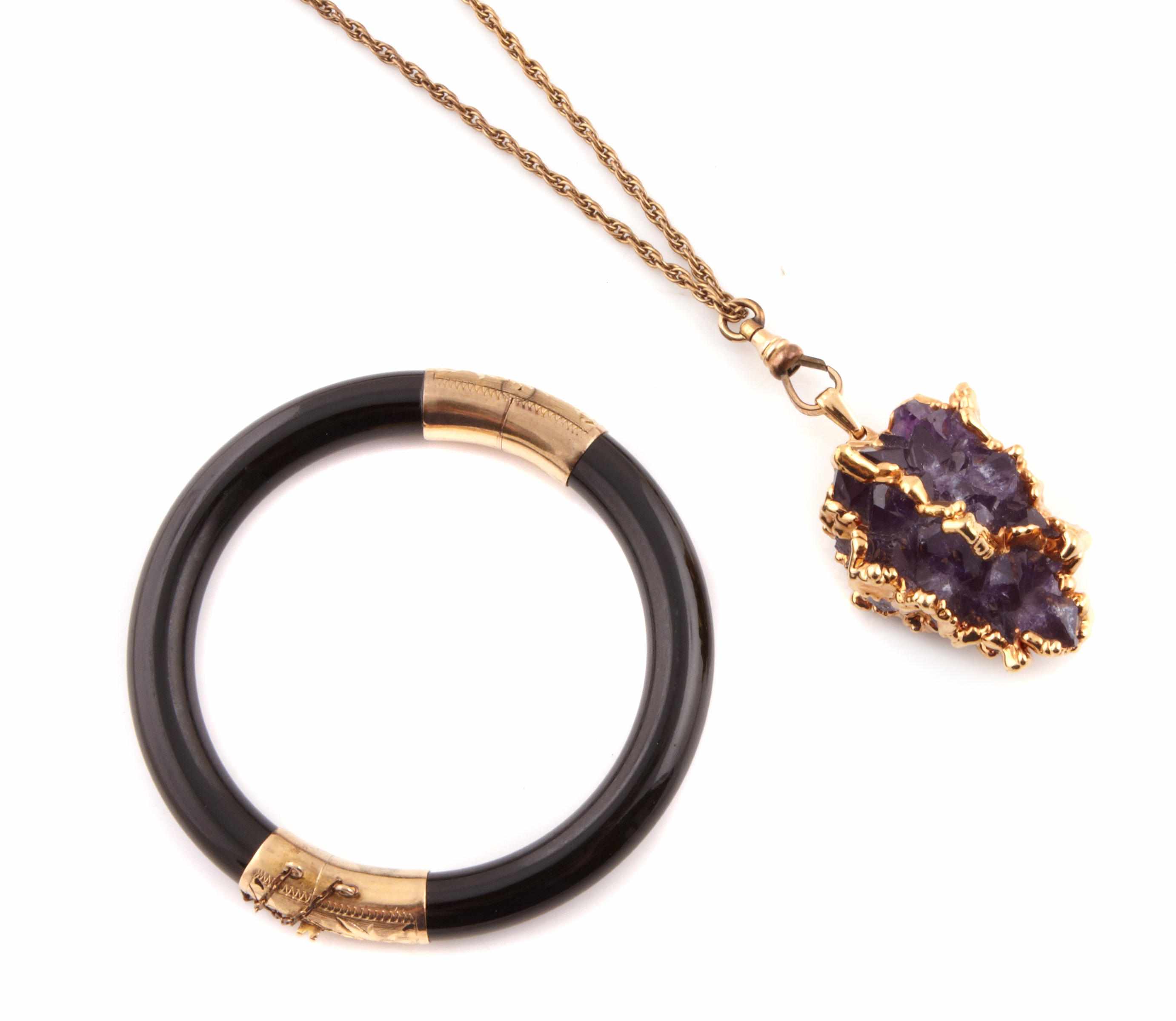 Appraisal: An amethyst crystal and gold pendant with chain together with