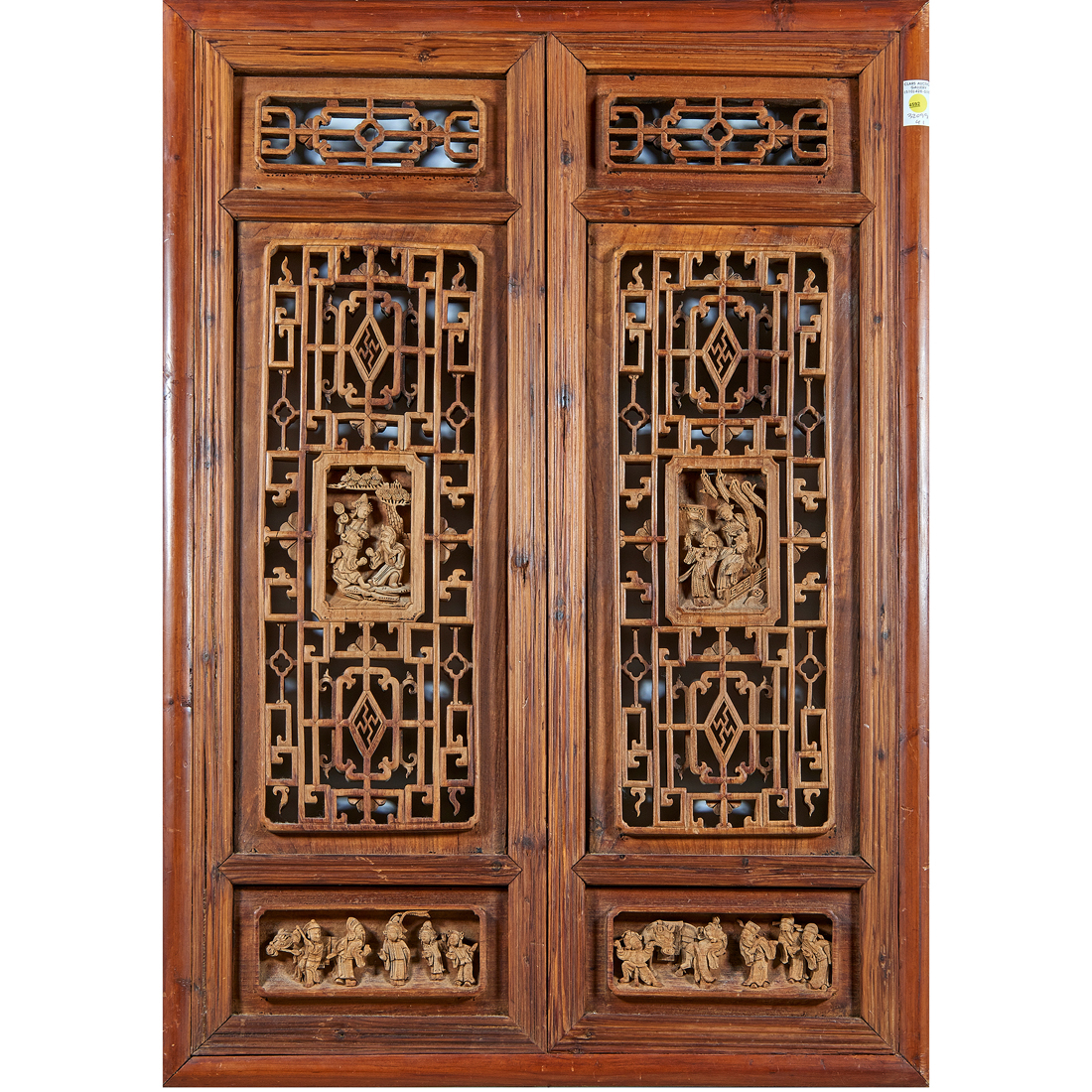 Appraisal: Pair of Chinese carved wood windows carved with various figures