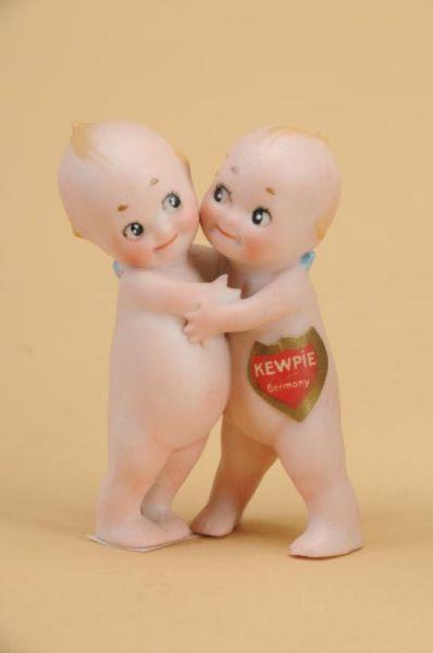 Appraisal: All Bisque Kewpie Huggers Germany ca all bisque action figure