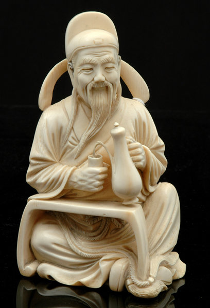 Appraisal: A CARVED IVORY FIGURE th Century Depicting a bearded Chinese