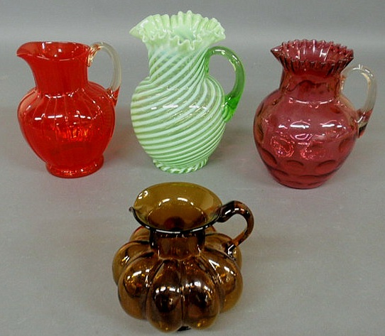 Appraisal: Four glass pitchers- amber Clevenger h green swirl h cranberry