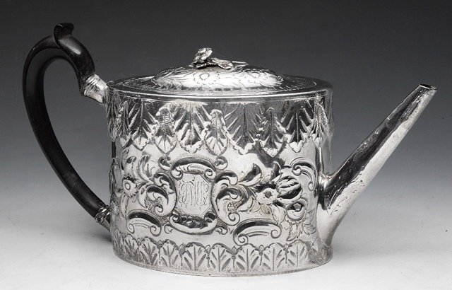 Appraisal: A GEORGE III SILVER TEAPOT with later embossed decoration and