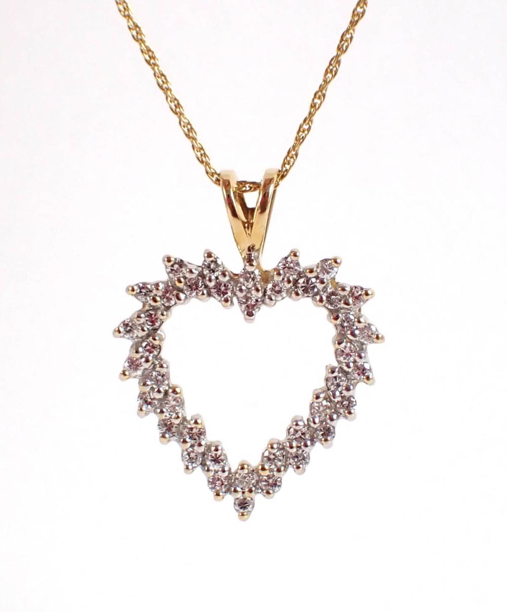 Appraisal: DIAMOND AND FOURTEEN KARAT GOLD HEART PENDANT NECKLACE the open