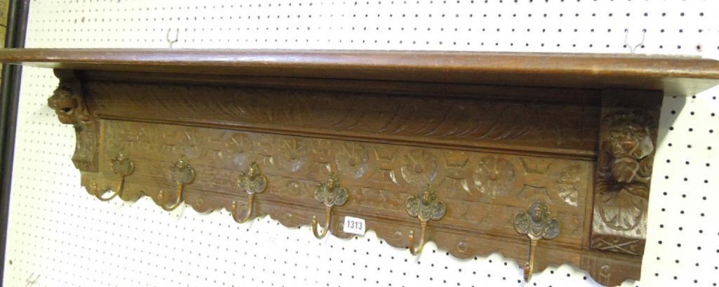 Appraisal: A Victorian oak wall shelf coat rack with carved lions