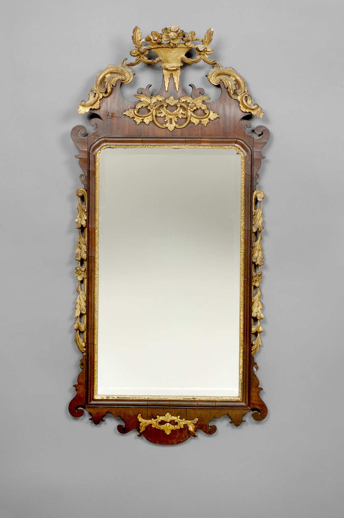 Appraisal: GEORGE III STYLE MAHOGANY AND PARCEL-GILT MIRROR The pierced and