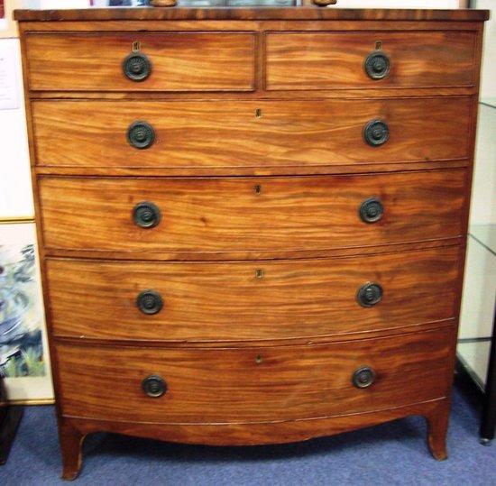 Appraisal: A Regency mahogany and chequer banded bowfront chest the shaped