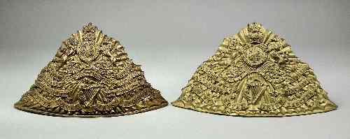 Appraisal: Two embossed gilt brass Lancers helmet plates relating to the