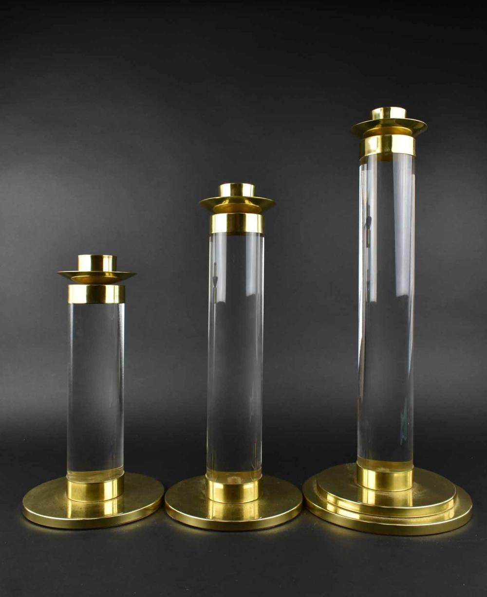 Appraisal: THREE CONTEMPORARY LUCITE BRASS CANDLESTICKSCirca In the manner of Karl