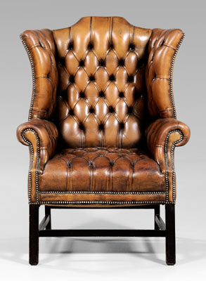 Appraisal: Chippendale style tufted leather-upholstered wing chair arched back and rolled