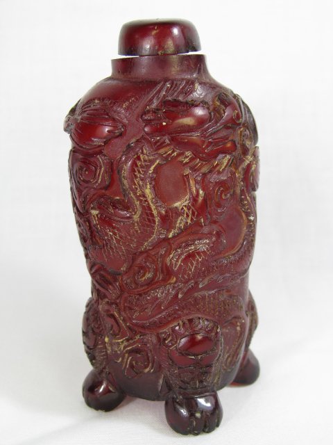 Appraisal: Cylinder shape Chinese carved footed snuff bottle Measures tall by