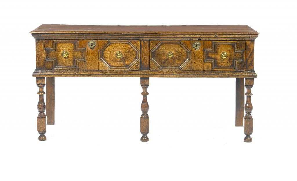 Appraisal: AN OAK DRESSER with boarded top and fitted two geometric