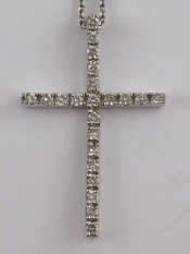 Appraisal: A white metal tests carat gold diamond set cross pendant