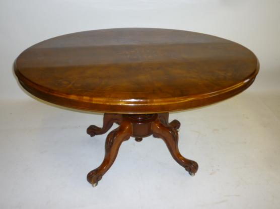 Appraisal: A VICTORIAN WALNUT LOO TABLE the quarter veneered moulded edged