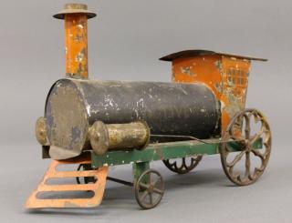 Appraisal: Early tin locomotive Early painted and stenciled tin toy steam