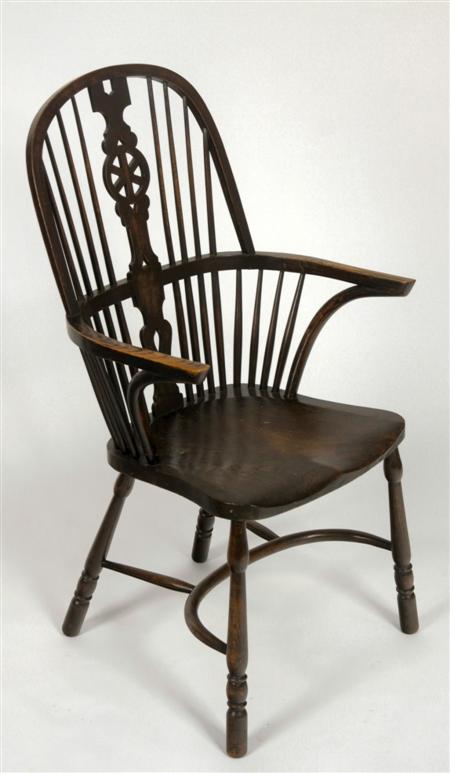 Appraisal: An elm wheel back Windsor chair the arched back over