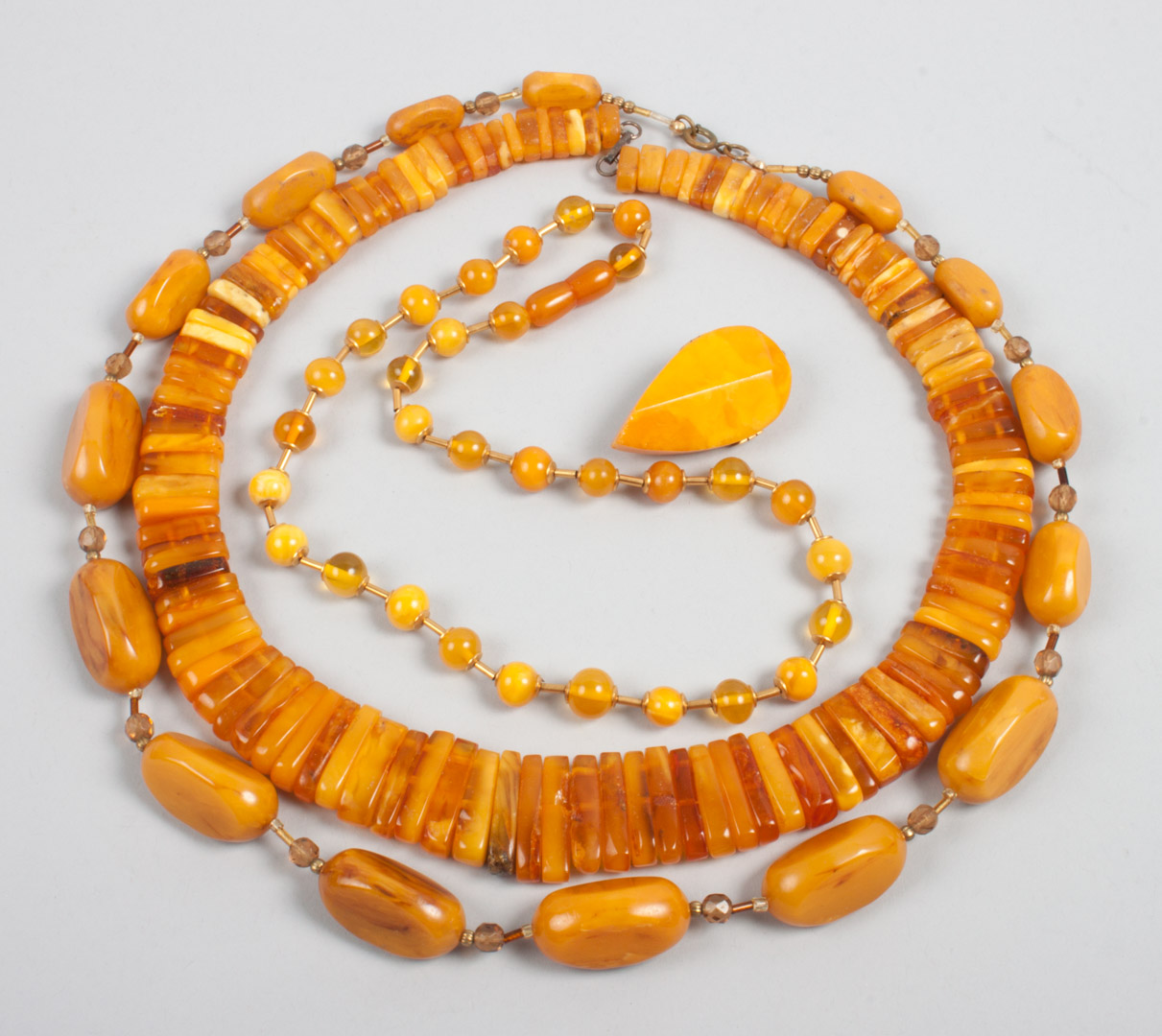 Appraisal: Three assorted butterscotch amber necklaces the longest- in together with