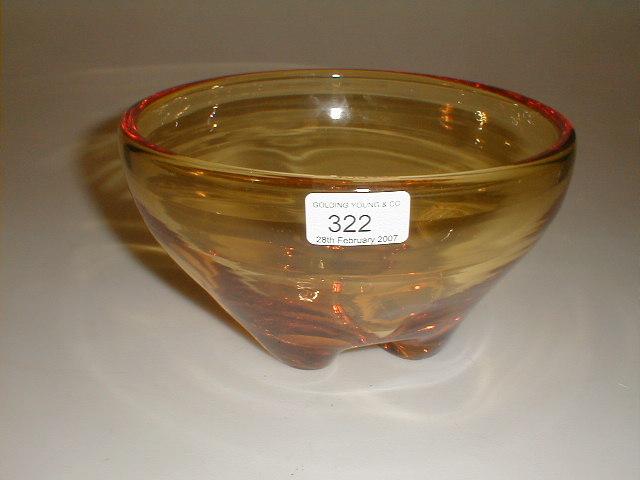 Appraisal: A Whitefriars heavy amber glass bowl on four moulded and