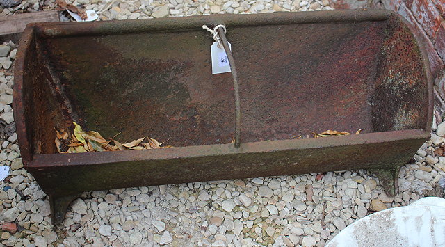 Appraisal: AN OLD CAST IRON FEEDING TROUGH with curved top cm