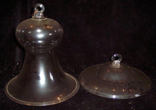 Appraisal: A glass bell shaped ceiling protector cm high and a