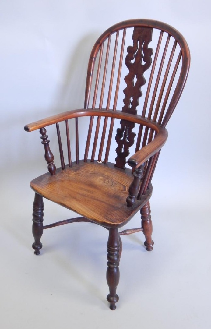 Appraisal: A yew ash and elm Windsor chair with a pierced