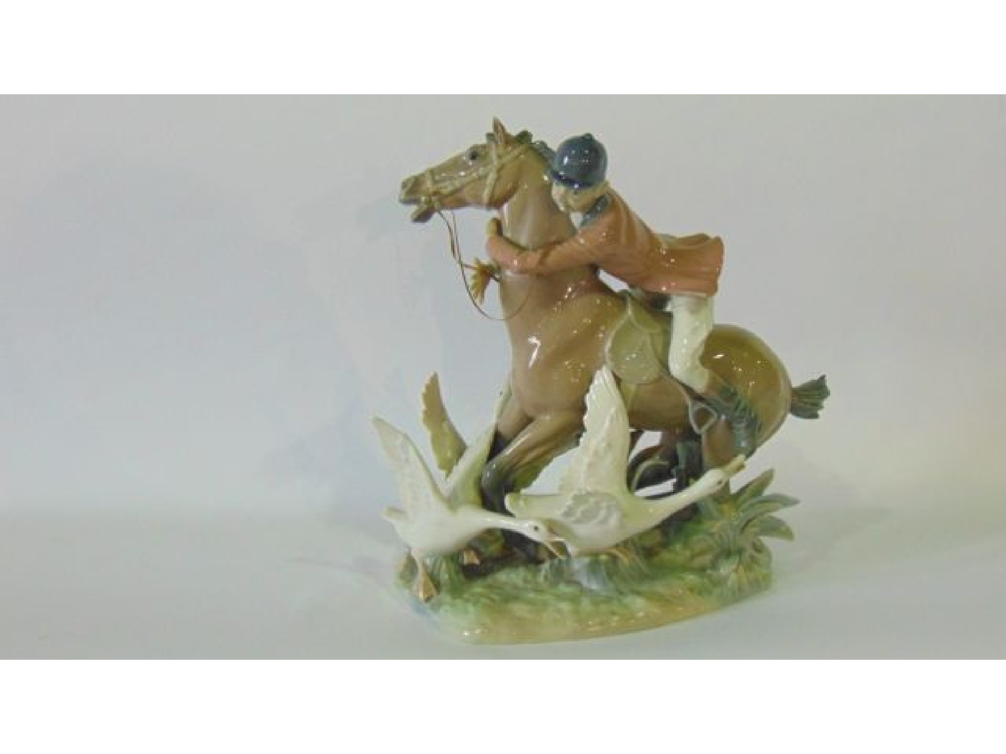 Appraisal: A large humorous Lladro figure group of a huntsman clasping