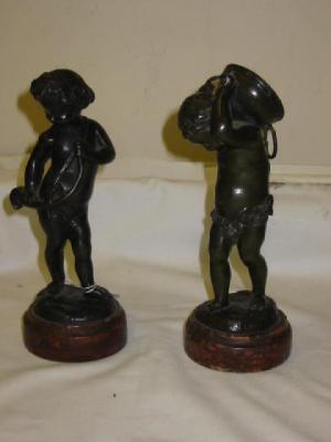 Appraisal: A PAIR OF BACCANALIAN PUTTI one carrying a vat and