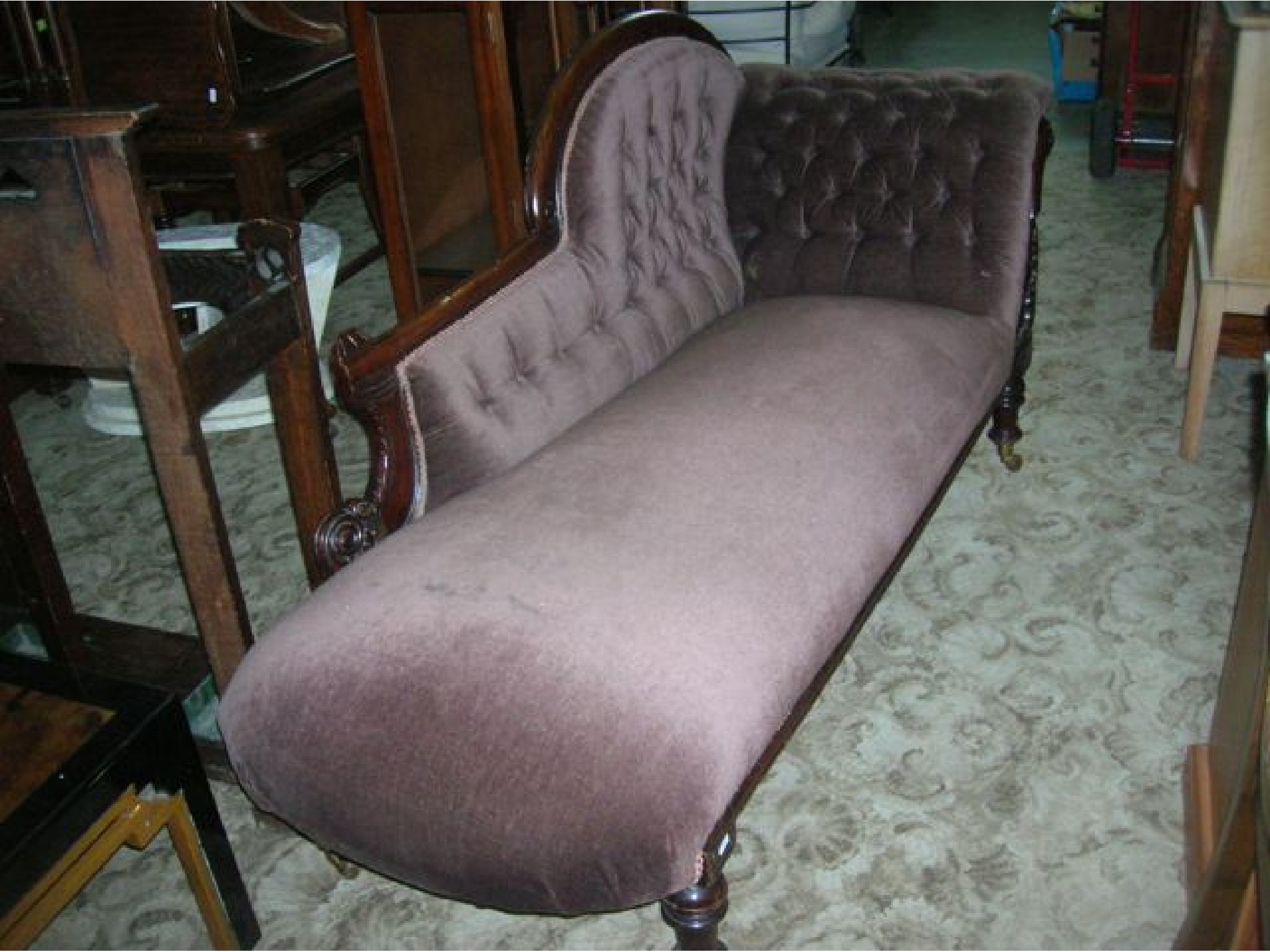 Appraisal: A Victorian chaise lounge with upholstered seat button back and