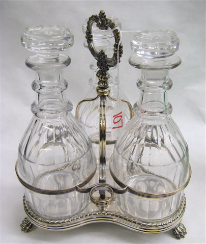 Appraisal: SILVER PLATED THREE-BOTTLE TANTALUS an ornate stand with decorated center