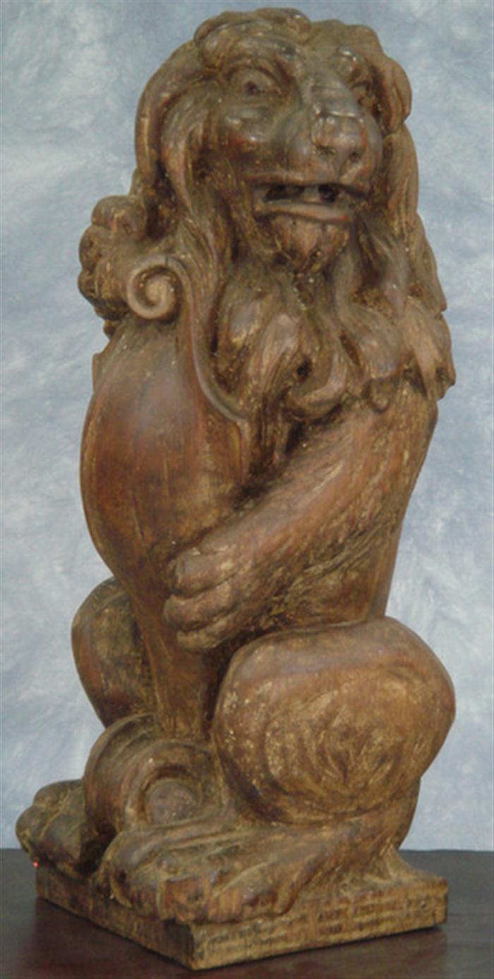 Appraisal: Carved pine figure of a lion standing on haunches holding