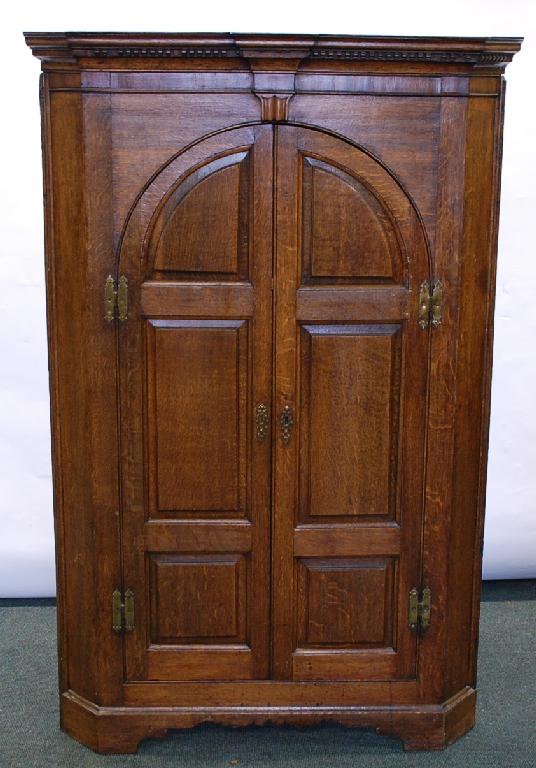 Appraisal: LATE EIGHTEENTH CENTURY FLOOR STANDING OAK CORNER CUPBOARD the breakfront