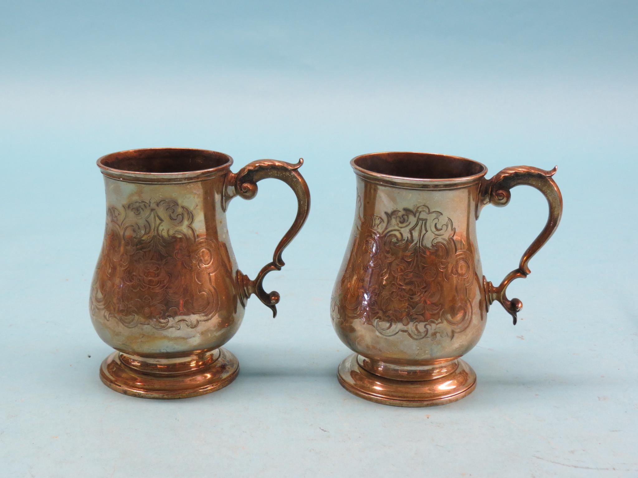 Appraisal: A pair of Victorian silver pint tankards baluster-shape with engraved