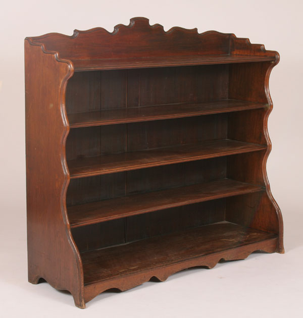 Appraisal: Late Victorian mahogany book shelf curved silhouette beveled shaped top