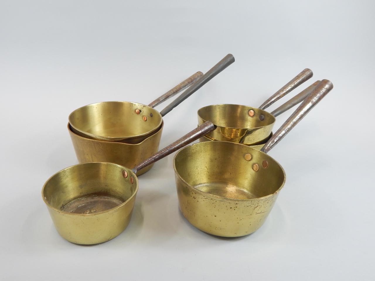 Appraisal: Six brass saucepans each with an iron handle various sizes