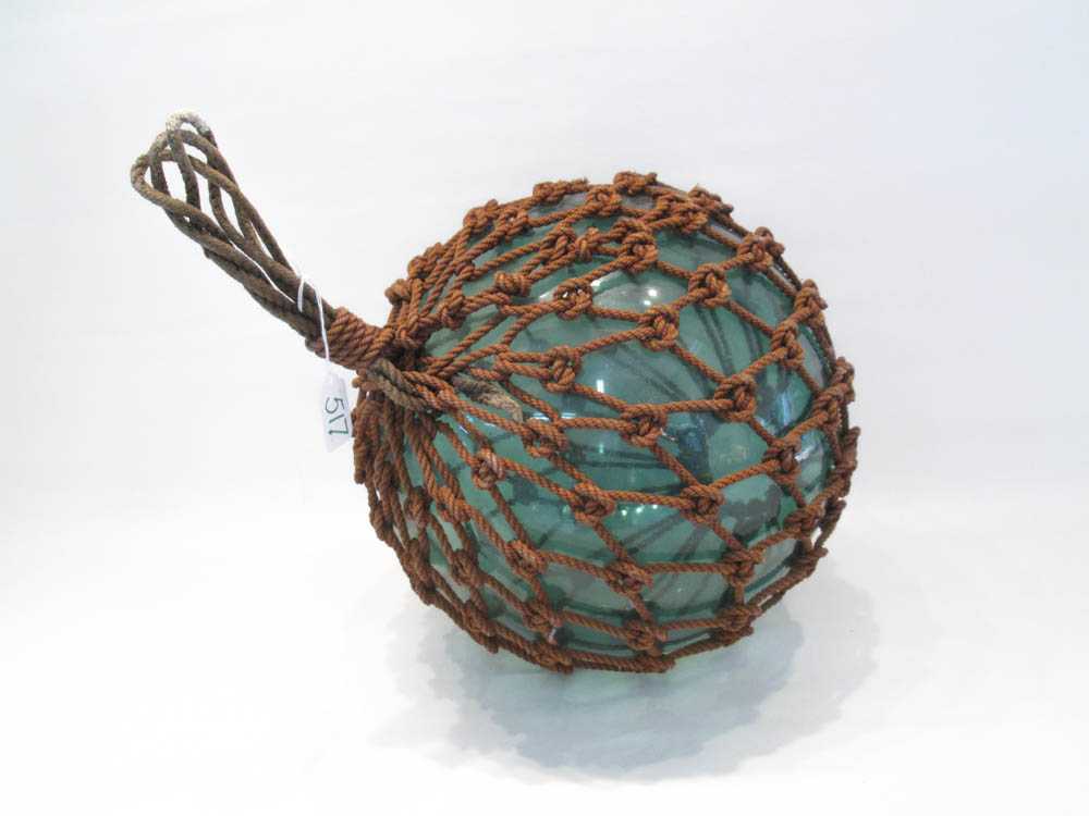 Appraisal: JAPANESE GLASS FISHING FLOAT with rope net blue-green glass float