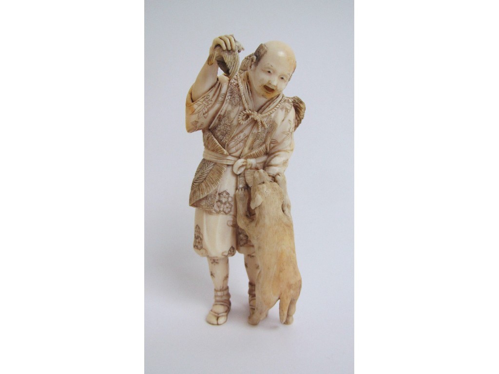 Appraisal: A Japanese ivory okimono carved with a huntsman offering a