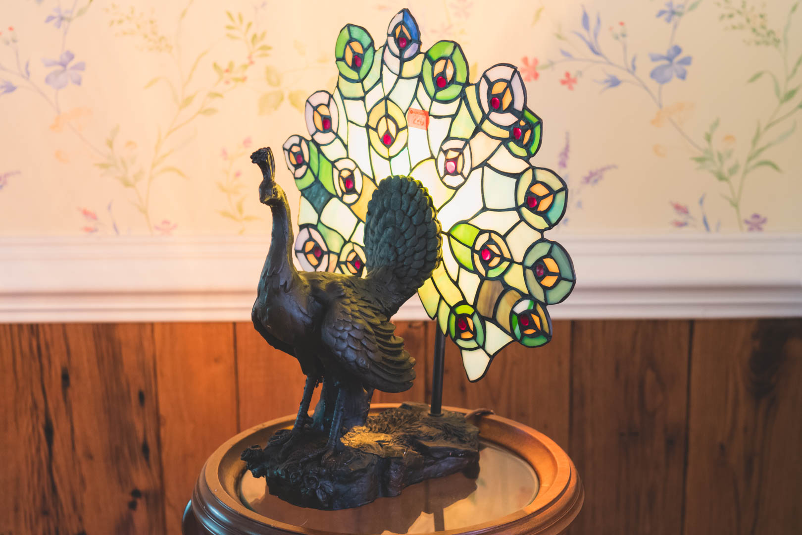 Appraisal: Cast metal and leaded glass peacock lamp in H