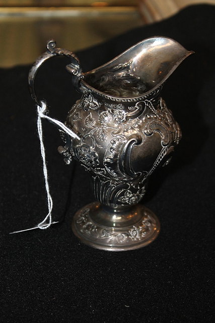 Appraisal: A GEORGIAN STYLE SILVER MILK JUG of baluster form with