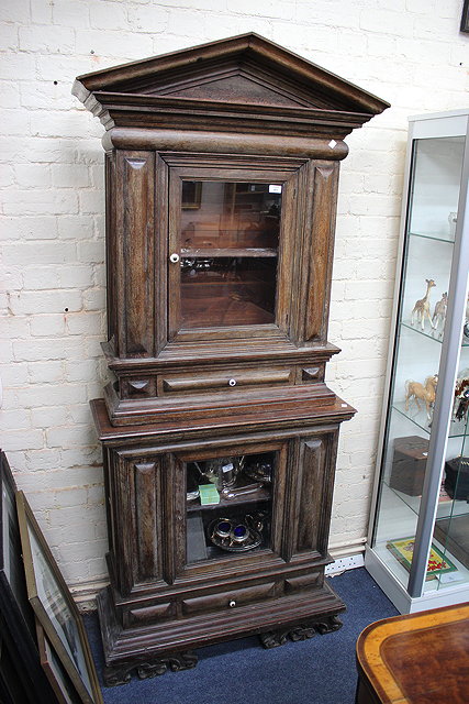 Appraisal: AN ANTIQUE AND LATER GLAZED TWO SECTIONED CABINET with moulded