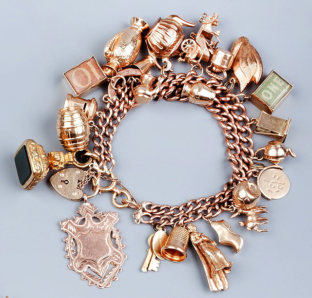 Appraisal: A CHARM BRACELET the double row graduated curb-link bracelet stamped