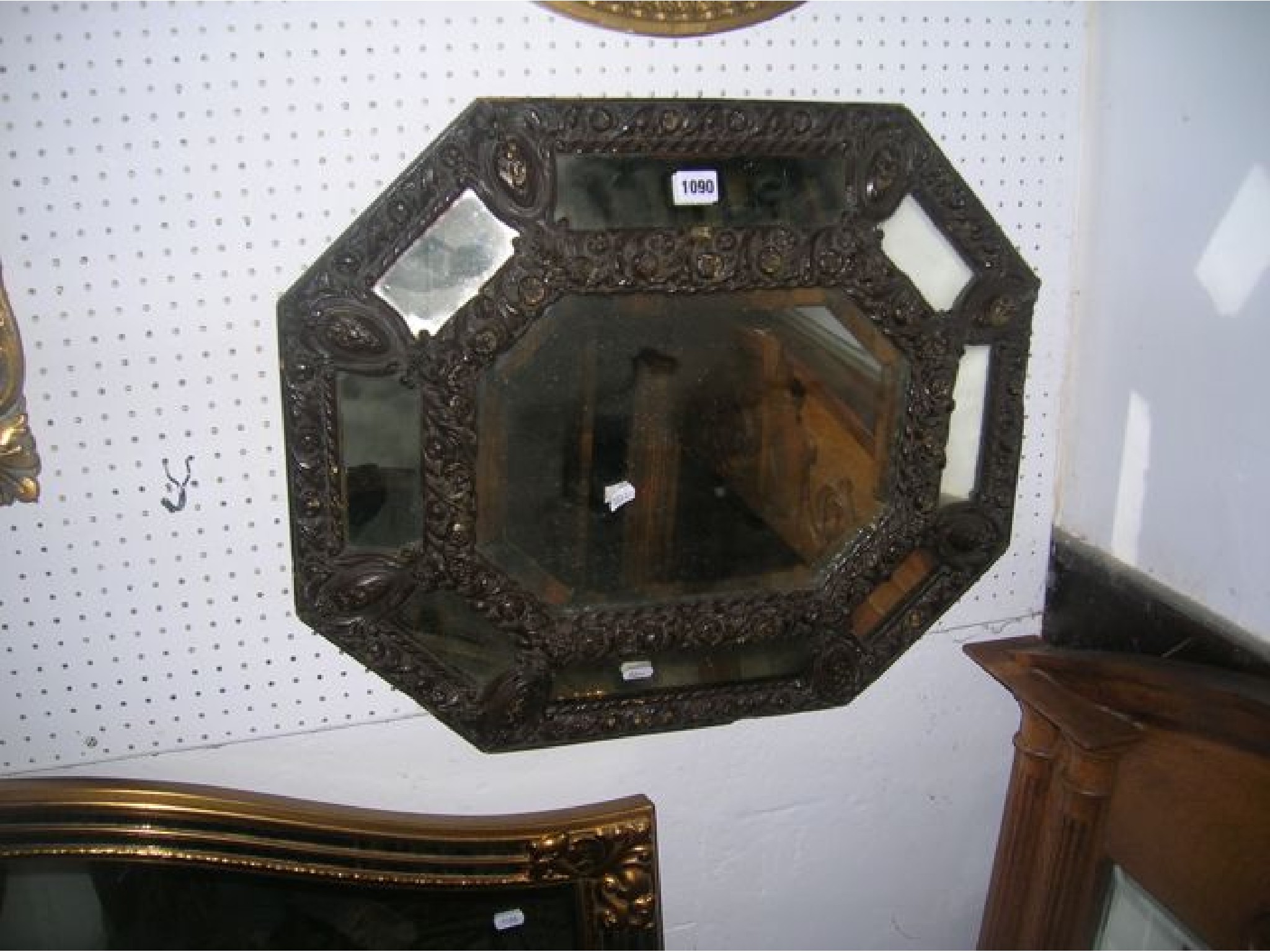 Appraisal: A stained wooden framed wall mirror of elongated octagonal form