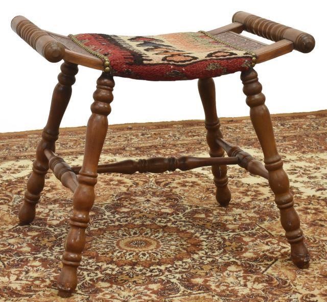 Appraisal: Saddle stool slightly curved seat with lunette carving kilim upholstery