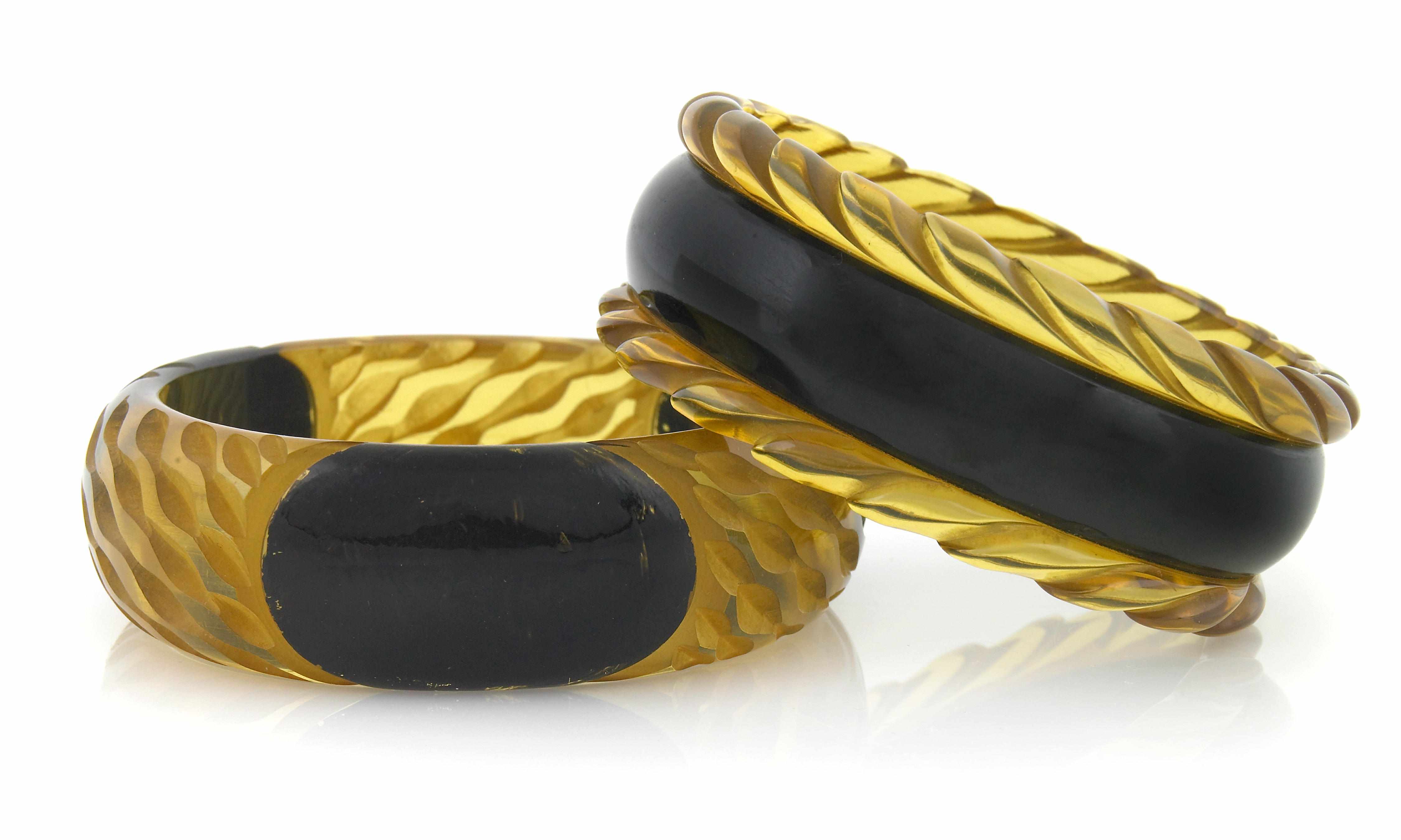 Appraisal: Two carved applejuice and black Bakelite bangle bracelets each diameter