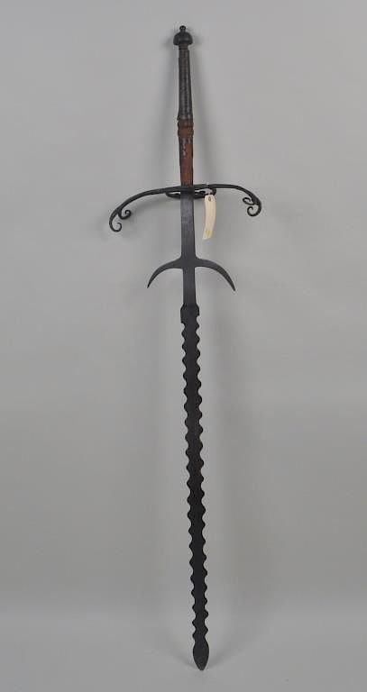 Appraisal: German Two-Handed Sword Flammenschwert the hilt with scrolled quillons and