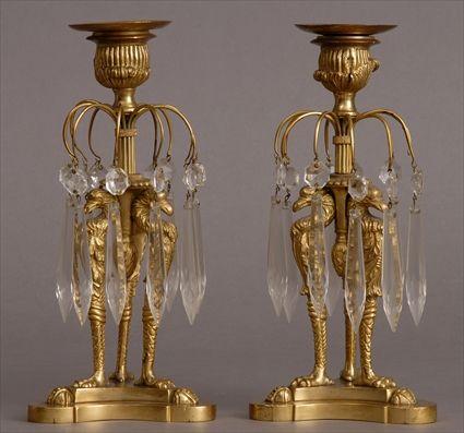 Appraisal: PAIR OF EMPIRE-STYLE CUT-GLASS MOUNTED GILT-METAL CANDLESTICKS Each tripod eagle-headed